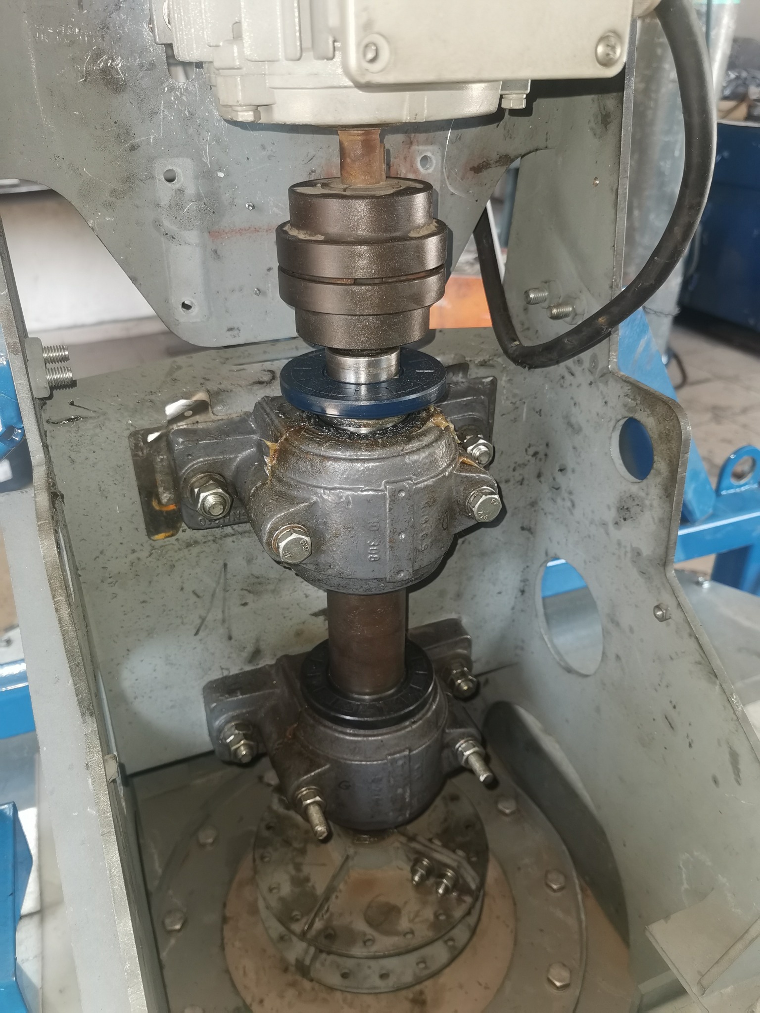 Szczegółowe ujęcie łożyska wału w maszynie przemysłowej w Chełmie Śląskim, widoczne ślady smaru i zużycia.