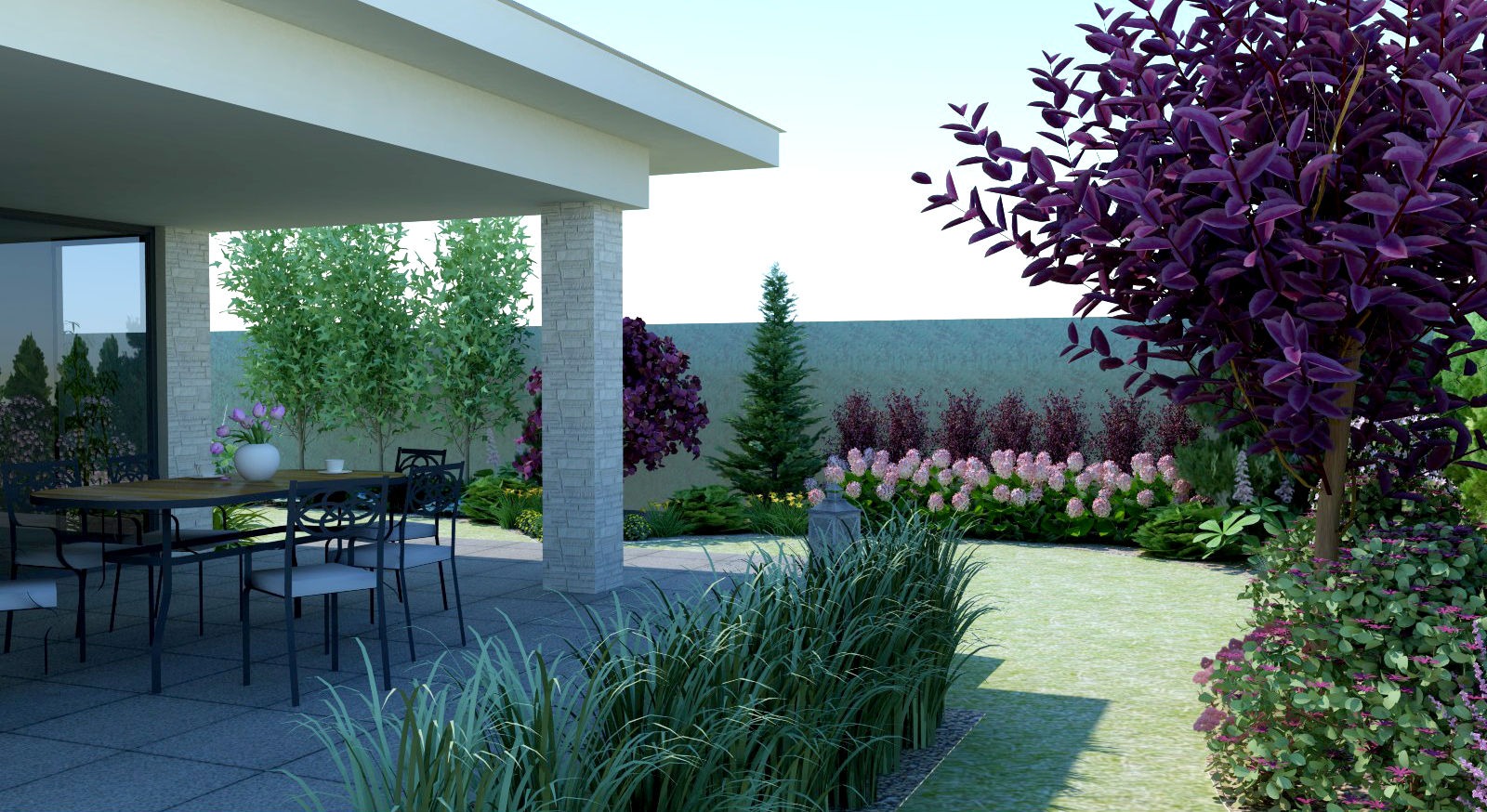 Zadaszony taras z kamienną kolumną, stołem i krzesłami, otoczony różnorodną roślinnością: trawy ozdobne, krzewy z fioletowymi liśćmi i kwitnące hortensje.