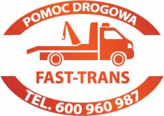 Grafika lawety w kolorze pomarańczowym z napisem 'POMOC DROGOWA' i numerem telefonu. Logo firmy FAST-TRANS na białym tle.