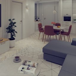 PMP KONKRET SPÓŁKA Z OGRANICZONĄ ODPOWIEDZIALNOŚCIĄ - Jasne wnętrze: salon z sofą, telewizorem, stołem jadalnym i kuchnią w tle. Parkiet w jodełkę, marmurowe akcenty, rośliny doniczkowe. Nowoczesny design.