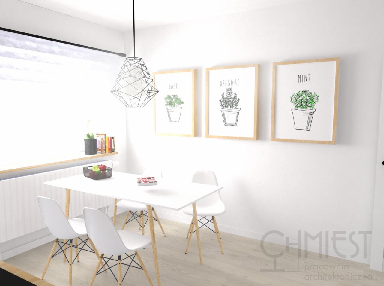 Jasna jadalnia z białym stołem i krzesłami. Na ścianie wiszą trzy obrazy z ziołami w doniczkach: bazylia, oregano i mięta. Nad stołem wisi nowoczesna lampa.