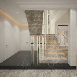 Ewelina Bulińska Architektura Wnętrz - Eleganckie wnętrze z marmurowymi schodami i czarną podłogą. Minimalistyczny design z białymi ścianami i złotymi akcentami. Widoczne detale wykończenia i oświetlenia.
