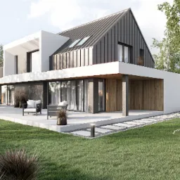 Nowoczesny dom z grafitowym dachem i białymi elementami, otoczony zielonym trawnikiem i drzewami. Widoczny taras z meblami ogrodowymi i oświetleniem.