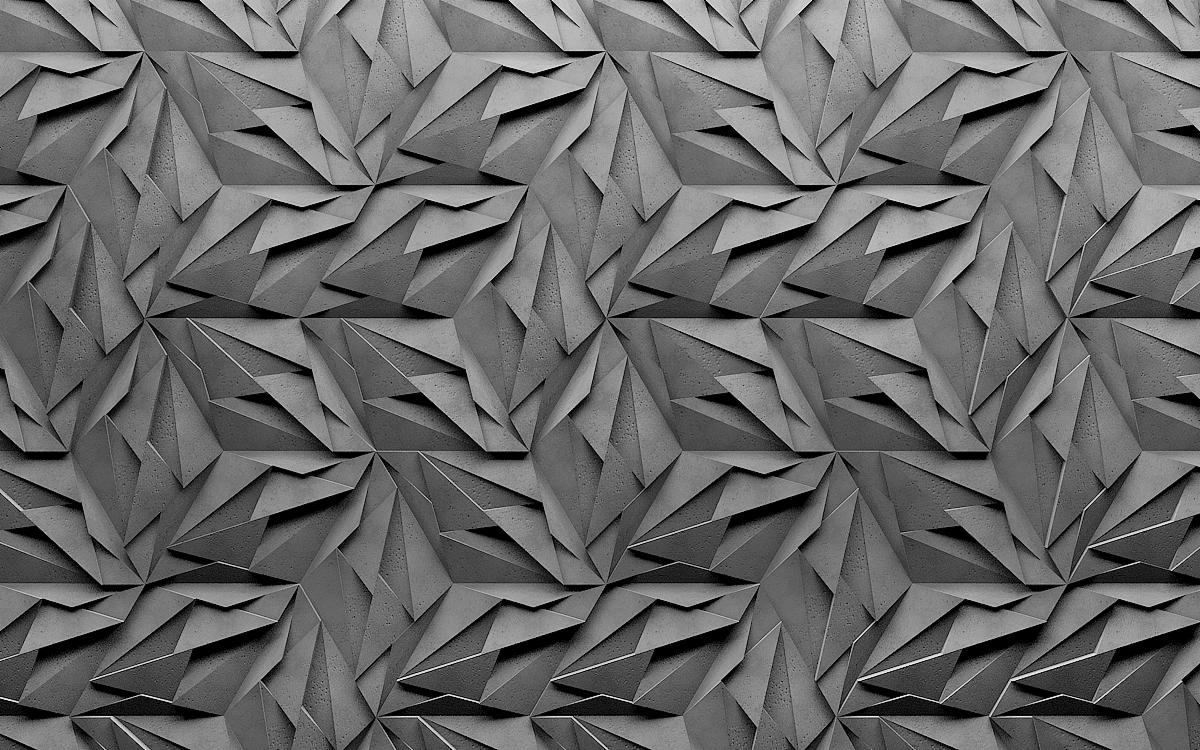 Abstrakcyjna, trójwymiarowa tekstura ściany z betonu architektonicznego w odcieniach szarości, tworząca geometryczny wzór z ostrymi krawędziami i wyraźnym światłocieniem.