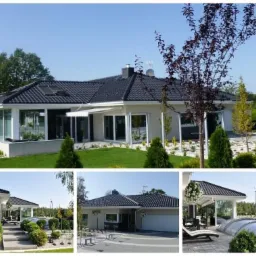 Nowoczesny parterowy dom z ciemną dachówką, dużymi oknami i przeszklonym ogrodem zimowym, otoczony zadbanym trawnikiem i ozdobnymi krzewami.