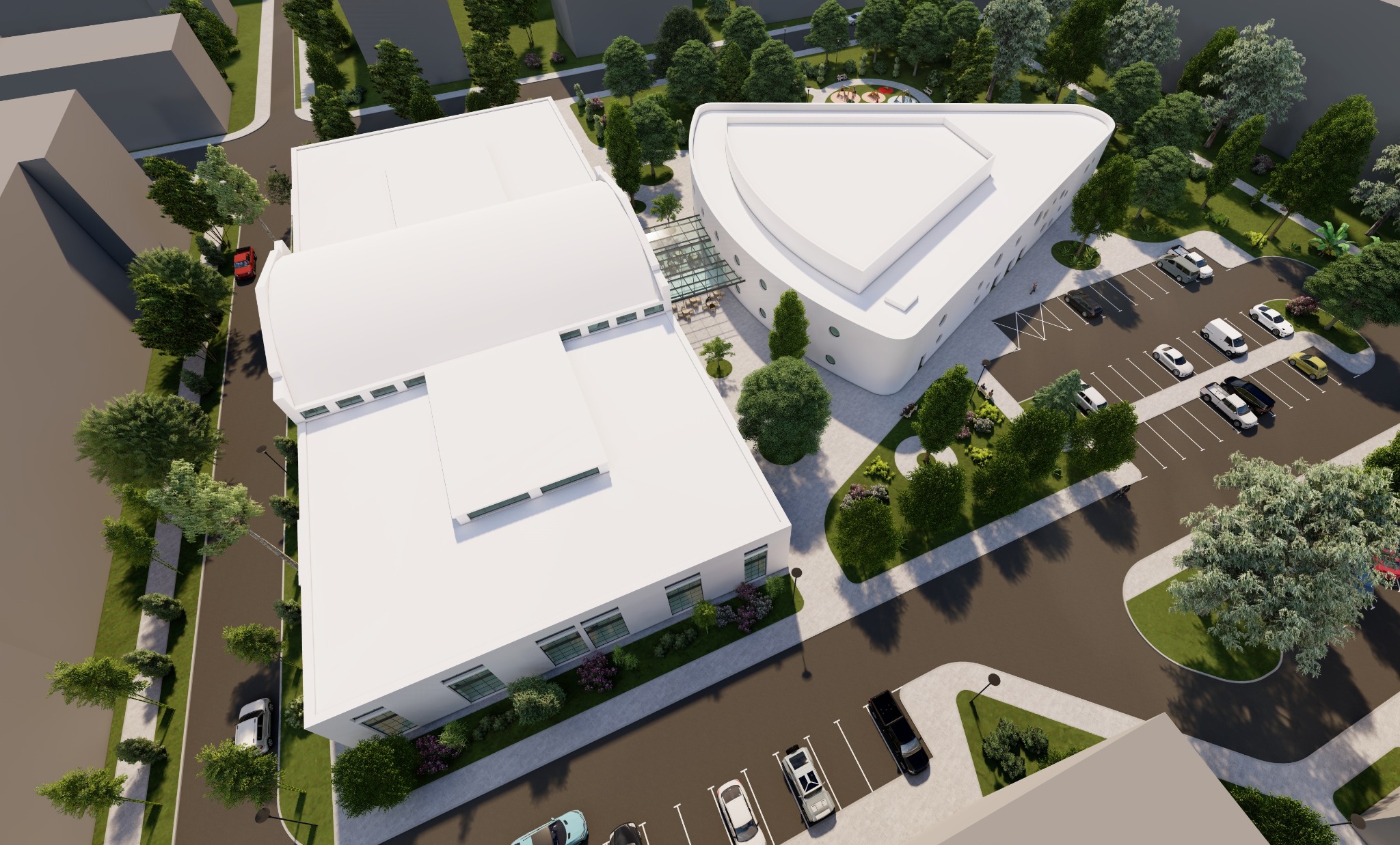 Wizualizacja z lotu ptaka nowoczesnego budynku usługowego z parkingiem i zielenią, prezentująca architekturę z zaokrąglonymi elementami i szklanym łącznikiem.