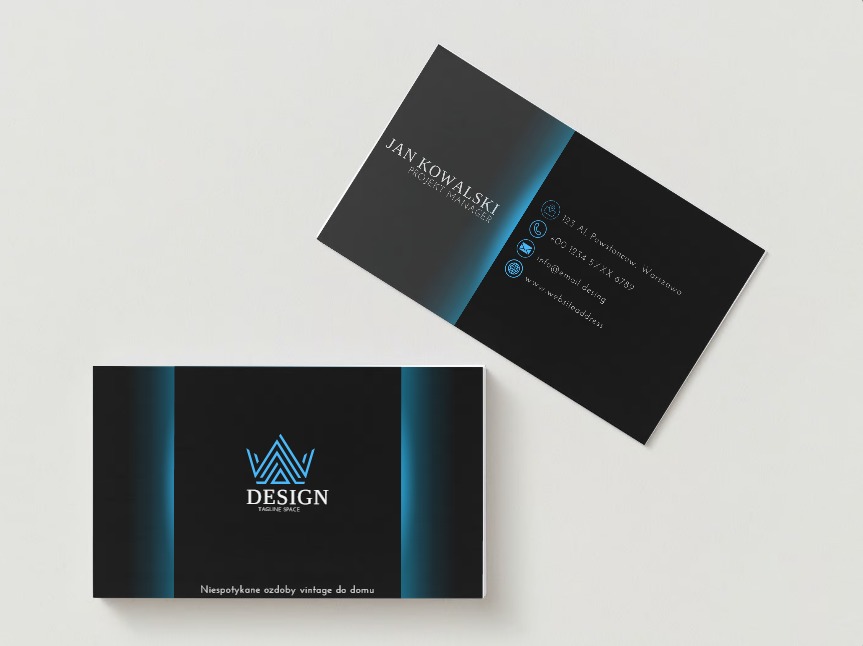 Dwie wizytówki w odcieniach czerni z niebieskimi akcentami, jedna leży płasko, druga jest lekko pod kątem, prezentują logo firmy Design Tagline Space oraz dane kontaktowe Jana Kowalskiego, Project...