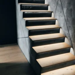 Nowoczesne schody z podświetleniem LED, drewniane stopnie i betonowe ściany, minimalistyczny design.