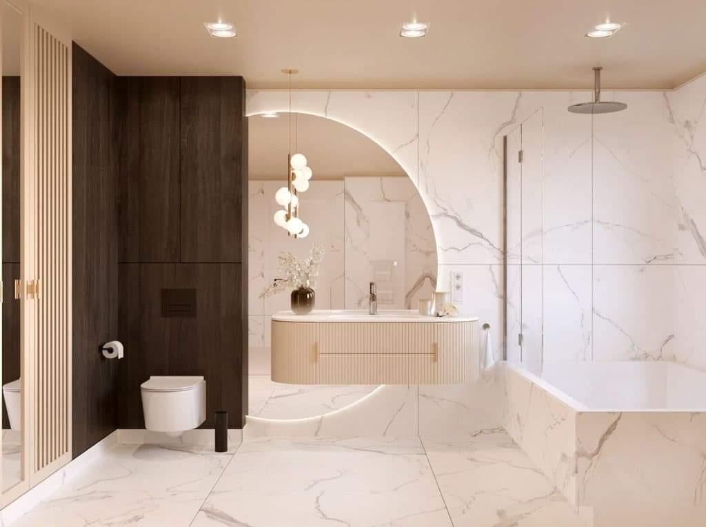 Elegancka łazienka z marmurowymi płytkami, podświetlanym lustrem w kształcie półksiężyca, wiszącą szafką umywalkową z ryflowanym frontem i nowoczesną armaturą.