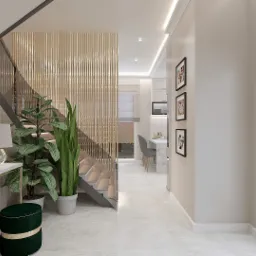 Nowoczesny przedpokój z marmurową konsolą, kwiatami, lampą, schodami z drewnianą ażurową balustradą oraz widokiem na kuchnię z jadalnią w tle.