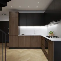 Nowoczesna kuchnia z drewnianymi i czarnymi szafkami, białym blatem, płytą gazową, schodami spiralnymi w tle i parkietem w jodełkę na podłodze.