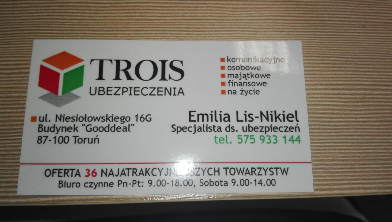 Wizytówka firmy ubezpieczeniowej Trois z Torunia, oferującej ubezpieczenia komunikacyjne, osobowe, majątkowe, finansowe i na życie, z adresem biura i numerem telefonu do specjalistki Emilii...