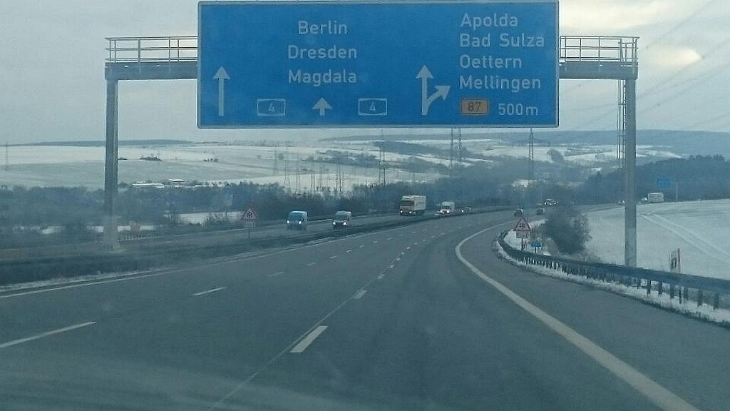 Droga ekspresowa z niebieskim znakiem drogowym wskazującym kierunki na Berlin, Drezno, Magdale, Apolda, Bad Sulza, Oettern i Mellingen.