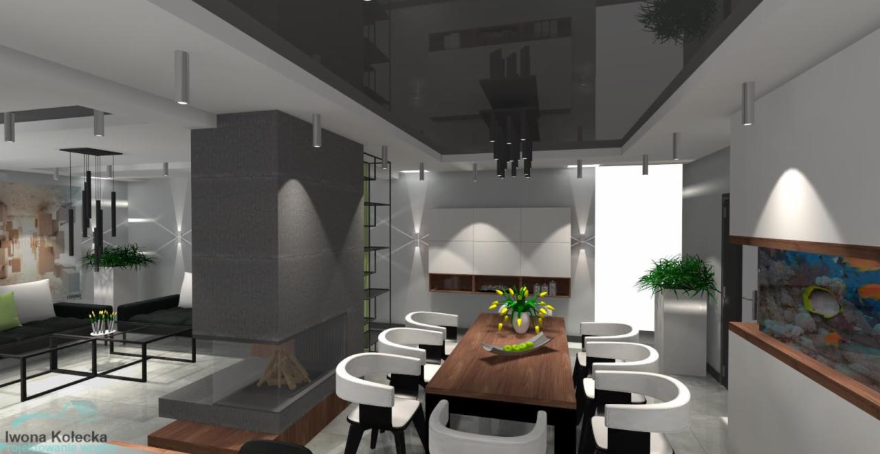Wizualizacja nowoczesnego salonu z jadalnią: szary kominek z drewnem, stół z białymi krzesłami, akwarium z rybami, czarny sufit z oświetleniem punktowym i geometryczne lampy wiszące.