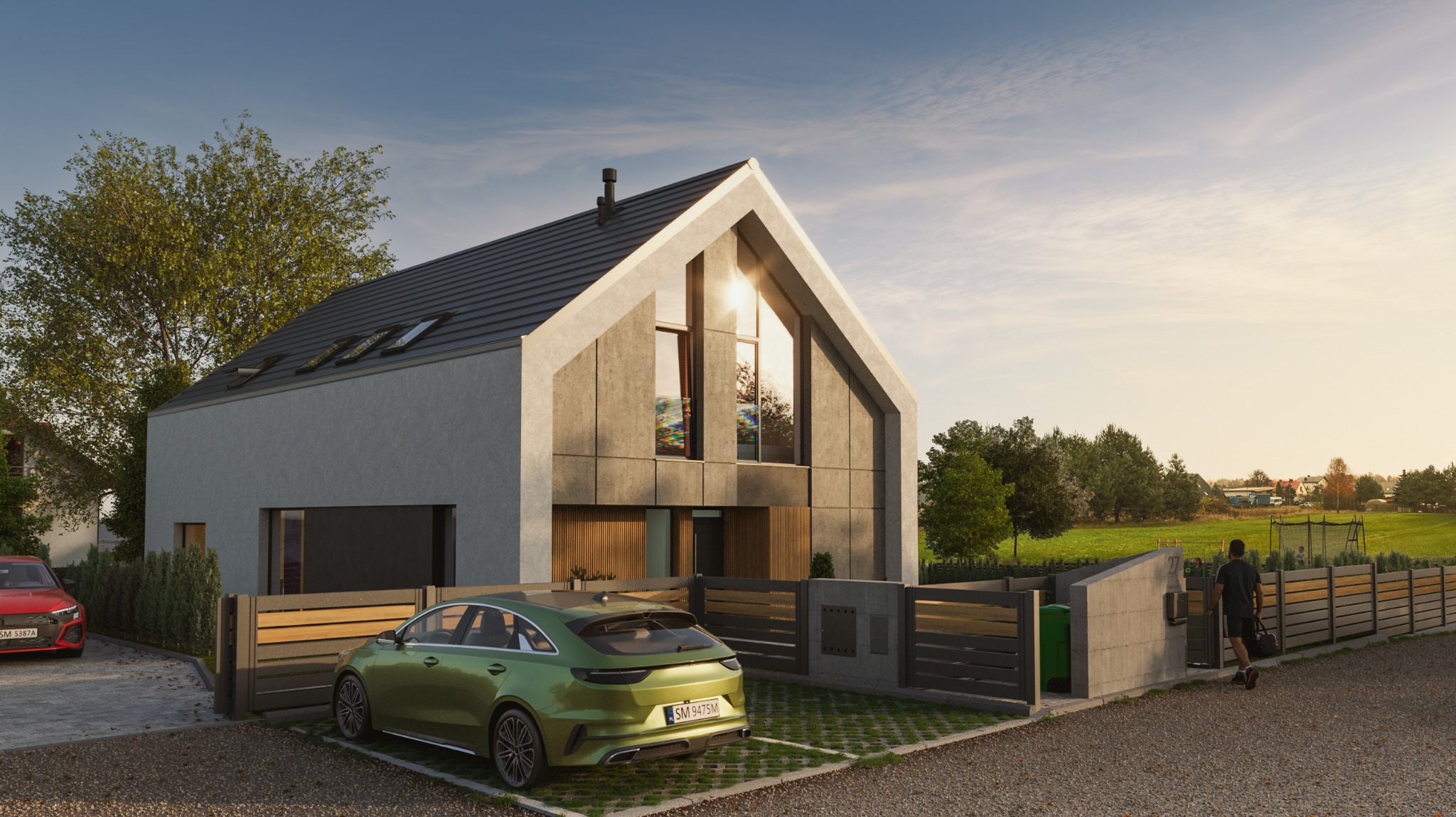 Nowoczesny dom jednorodzinny z szarą elewacją i dwuspadowym dachem. Na podjeździe zielony samochód, w tle widoczny krajobraz z zielonymi polami i drzewami.