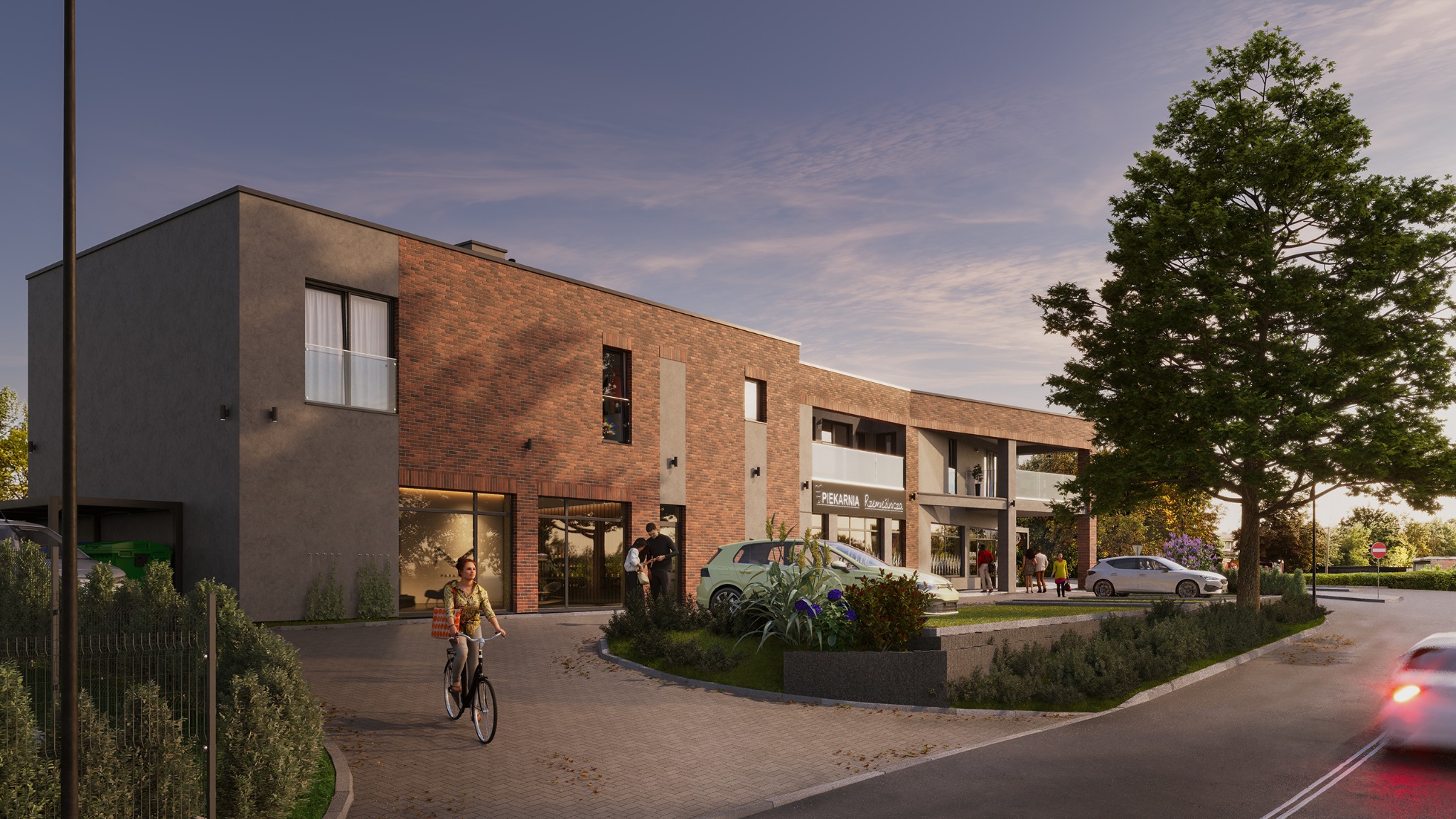 Wizualizacja budynku usługowego z ceglaną elewacją i elementami szarości, otoczonego zielenią. Osoba na rowerze wjeżdża na teren posesji. Widoczny szyld 'Piekarnia Rzemieślnicza'.