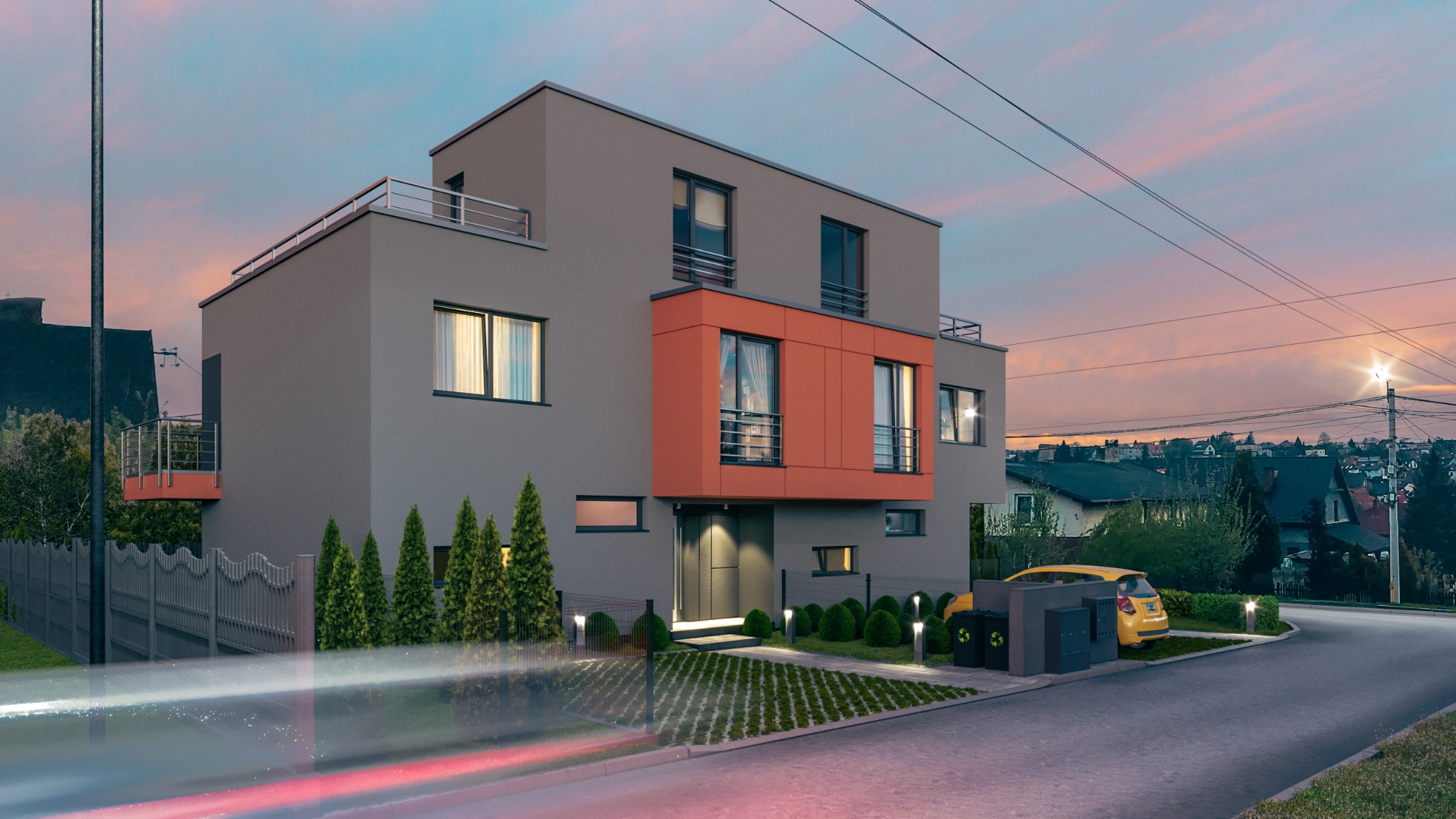 Nowoczesny bliźniak z szarą elewacją i pomarańczowym akcentem, widok z ulicy o zmierzchu, widoczne światła samochodu i oświetlenie ogrodu.