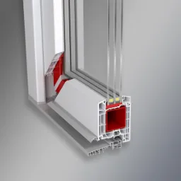 Przekrój okna z trzema szybami, ukazujący wewnętrzną konstrukcję ramy z czerwonym wzmocnieniem oraz system uszczelnień.