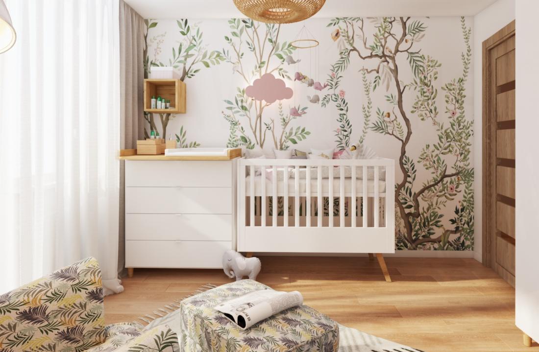Pokój dziecięcy z białym łóżeczkiem i komodą z przewijakiem, ściana zdobiona tapetą z motywem drzew i zwierząt, rattanowa lampa sufitowa, fotel z wzorem liści, drewniana podłoga.