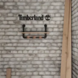 Ściana z cegły z logo Timberland i półką z rur w stylu industrialnym z trzema zaworami.