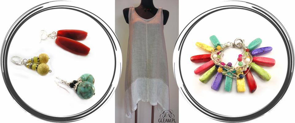 Kompozycja studyjna: przewiewna tunika na manekinie, kolczyki z czerwonymi, zielonymi i turkusowymi kamieniami oraz bransoletka z wielobarwnymi zawieszkami z kamieni.