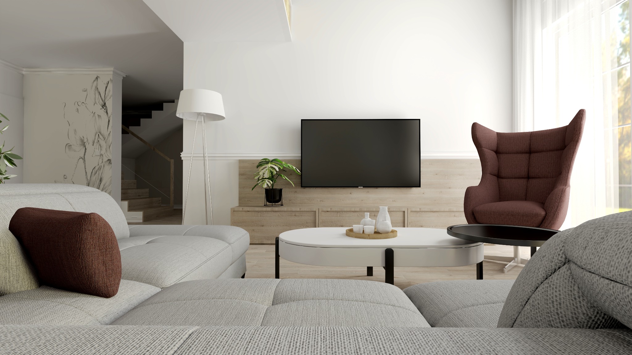 Jasny salon z szarą sofą modułową, brązowym fotelem uszak, białym stolikiem kawowym i ścianą telewizyjną z drewnianymi panelami oraz schodami w tle.