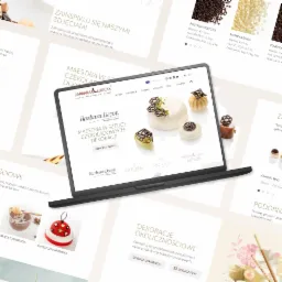 Laptop wyświetla stronę internetową z galerią zdjęć deserów czekoladowych, widoczne posypki i dekoracje w tle.