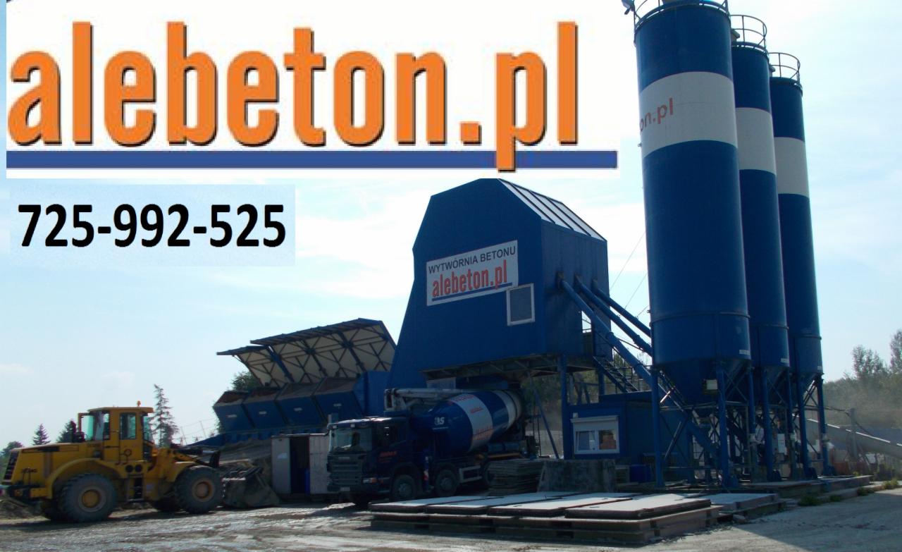 Kompleks budynków wytwórni betonu z silosami, betonomieszarką i ładowarką na placu, widoczny napis 'alebeton.pl' i numer telefonu.