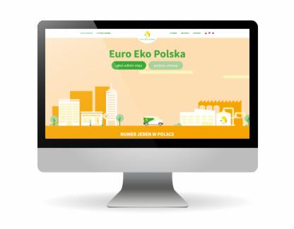 Monitor wyświetlający stronę internetową Euro Eko Polska z grafiką przedstawiającą miasto, fabrykę i zielony samochód dostawczy na pomarańczowym tle. Napis 'Numer Jeden w Polsce' na dole ekranu.