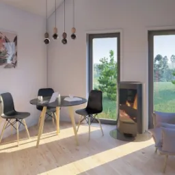 Jasne wnętrze domu w Ciechocinku z minimalistyczną kuchnią, okrągłym stołem z czarnymi krzesłami, kominkiem i widokiem na ogród przez duże okna.