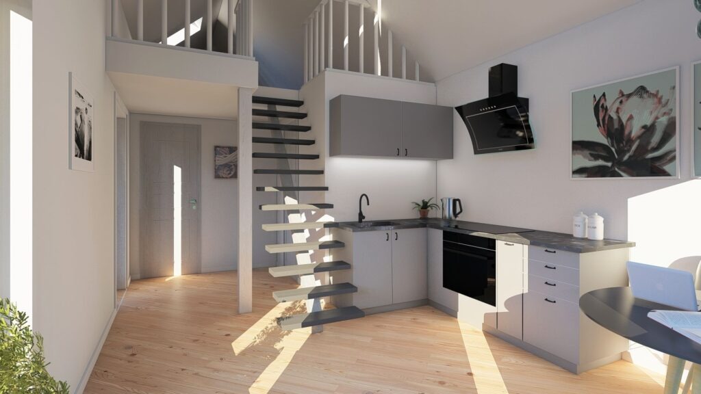Wizualizacja małej kuchni z szarymi szafkami, czarnym okapem i drewnianymi schodami prowadzącymi na antresolę, oświetlona promieniami słońca wpadającymi przez okno.