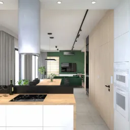 Wnętrze nowoczesnego mieszkania z otwartą kuchnią na salon, z zieloną ścianą w tle, drewnianym stołem i białymi meblami kuchennymi, oświetlone ledowymi lampami sufitowymi.