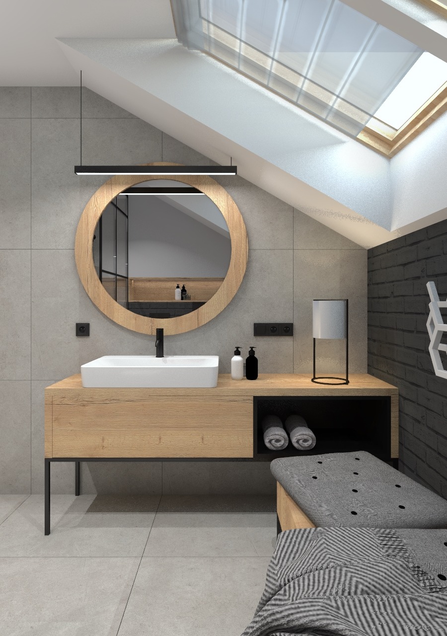 Nowoczesna łazienka na poddaszu ze skośnym sufitem i oknem dachowym, okrągłe lustro z drewnianą ramą, biała umywalka nablatowa, drewniana szafka pod umywalką z czarnymi nogami, czarna bateria...