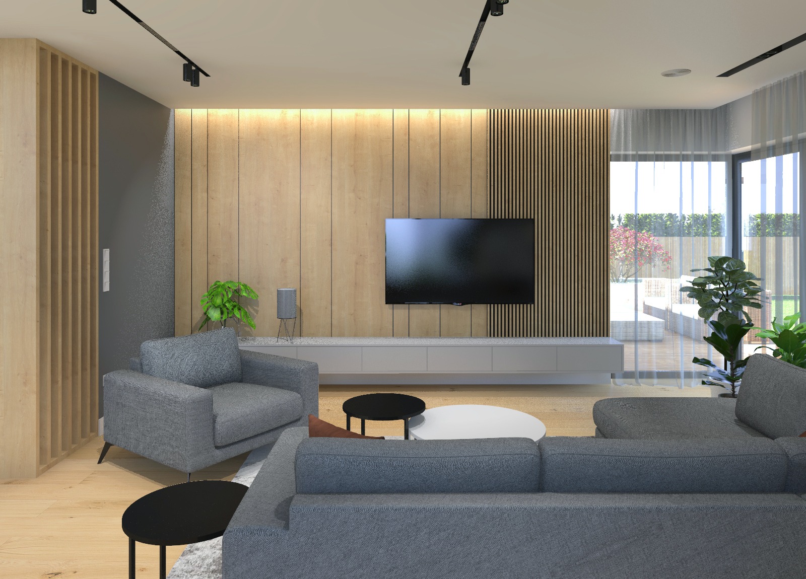 Wizualizacja salonu z drewnianą ścianą, szarą sofą modułową, fotelem i telewizorem na tle jasnej ściany z pionowymi panelami. Widoczne czarne lampy sufitowe i rośliny doniczkowe.