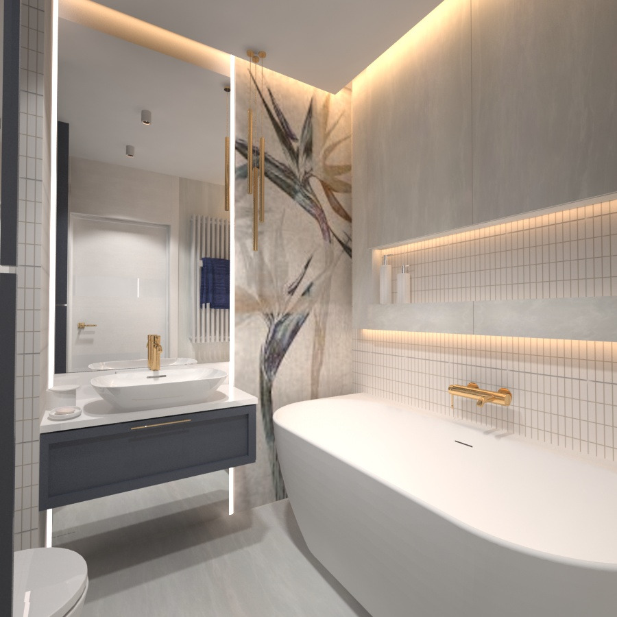 Nowoczesna łazienka z wolnostojącą wanną, umywalką nablatową na szafce w kolorze granatowym, podświetlanym lustrem i ścianą z motywem roślinnym.