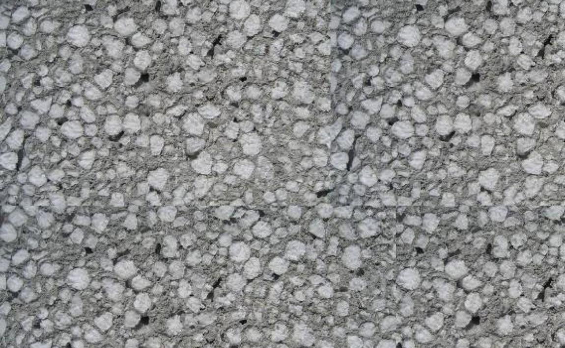 Szary beton komórkowy z widoczną porowatą strukturą, zbliżenie na powierzchnię.