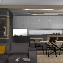 Nowoczesna aranżacja wnętrza z szarą sofą z żółtymi poduszkami, czarnymi krzesłami o geometrycznym wzorze przy drewnianym stole oraz zabudową kuchenną w odcieniach szarości.