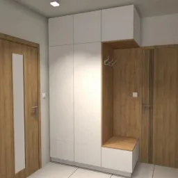 Biała szafa wnękowa z siedziskiem i wieszakami w przedpokoju, obok drewniane drzwi z przeszkleniem i drzwi z ciemnymi paskami.