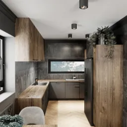 Nowoczesna kuchnia z drewnianymi szafkami, szarymi ścianami i parkietem w jodełkę, oświetlona punktowymi lampami sufitowymi i wiszącą lampą nad stołem.