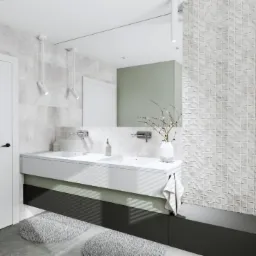 Nowoczesna łazienka z podwójną umywalką, bateriami ściennymi, białymi płytkami 3D, szarymi dywanikami i minimalistycznym oświetleniem punktowym.