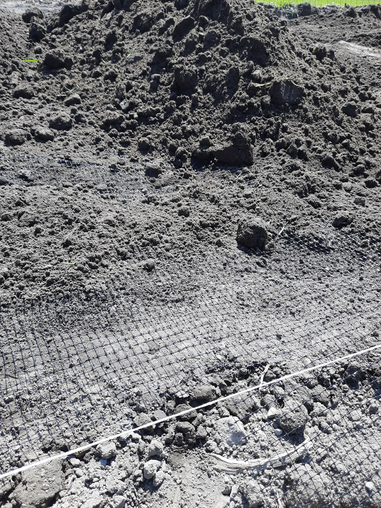 Przygotowany teren pod budowę z rozłożoną siatką wzmacniającą i wytyczonym sznurkiem.