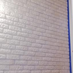 Ścianka z ciętej cegły, malowana na biało. 