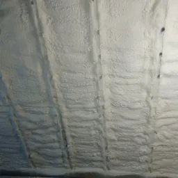 Poddasze w Grudziądzu po ociepleniu pianką PUR, widoczne drewniane belki konstrukcyjne i równomierna warstwa izolacji.