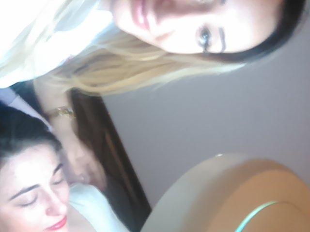 Klientka z zamkniętymi oczami podczas opalania natryskowego, widoczna twarz osoby wykonującej zabieg z góry.