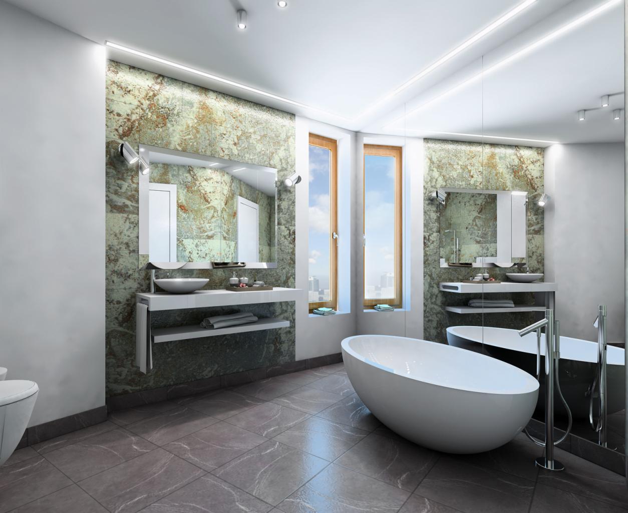 Nowoczesna łazienka z wolnostojącą białą wanną, podwójnym oknem z widokiem na miasto, umywalkami nablatowymi i ścianami wyłożonymi płytkami imitującymi marmur.