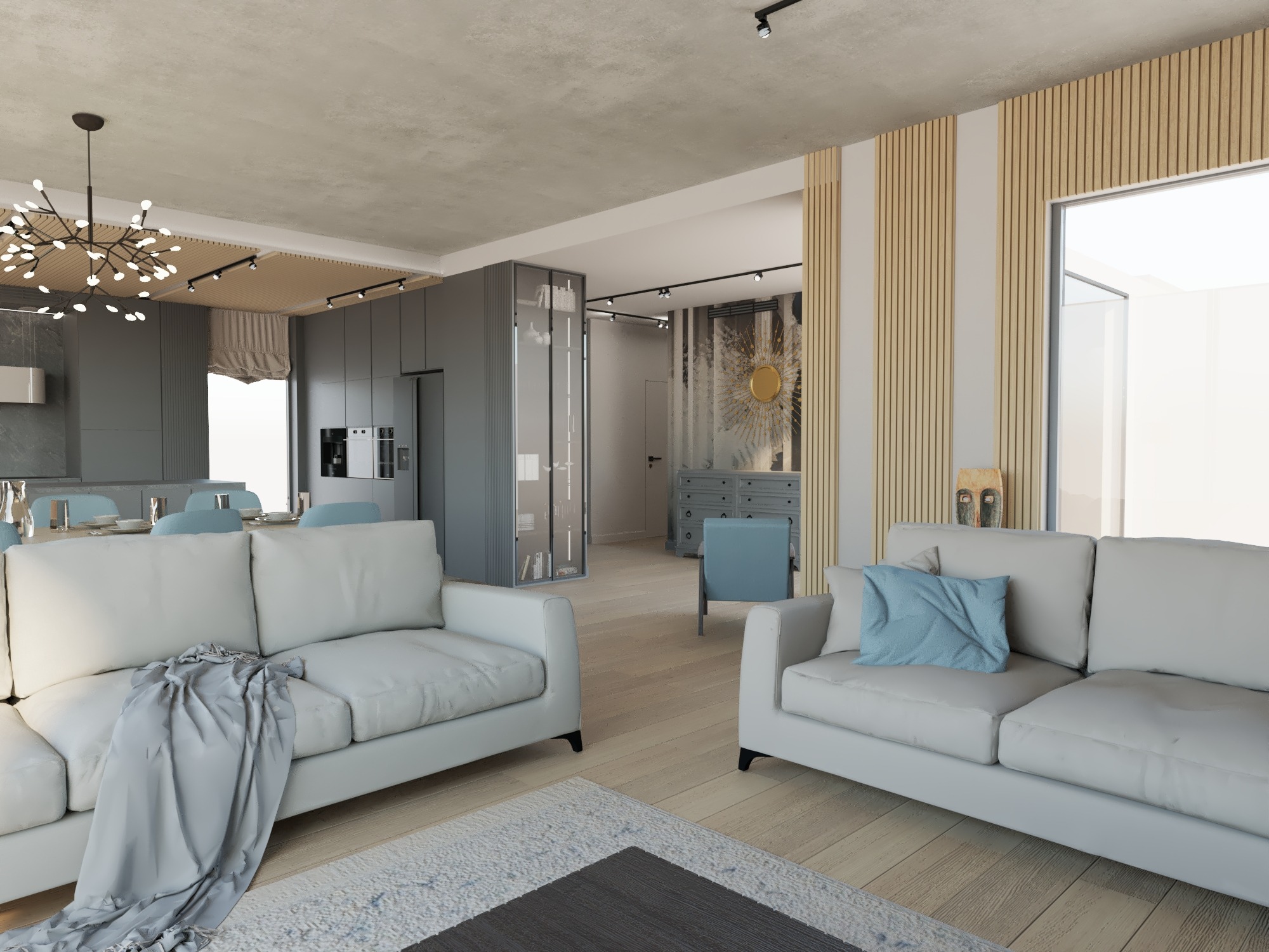 Jasne, przestronne wnętrze z dwoma białymi sofami, drewnianą ścianą z lamelami i otwartą kuchnią w szarościach, oświetlone nowoczesną lampą sufitową typu pająk.