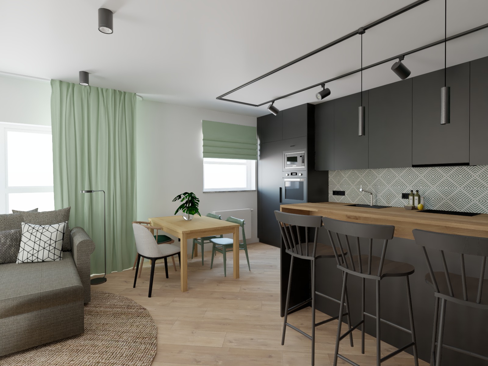 Nowoczesny salon z kuchnią w Zamieniu, z szarą sofą, drewnianym stołem i krzesłami w pastelowych odcieniach oraz czarną zabudową kuchenną z drewnianym blatem i hokerami.