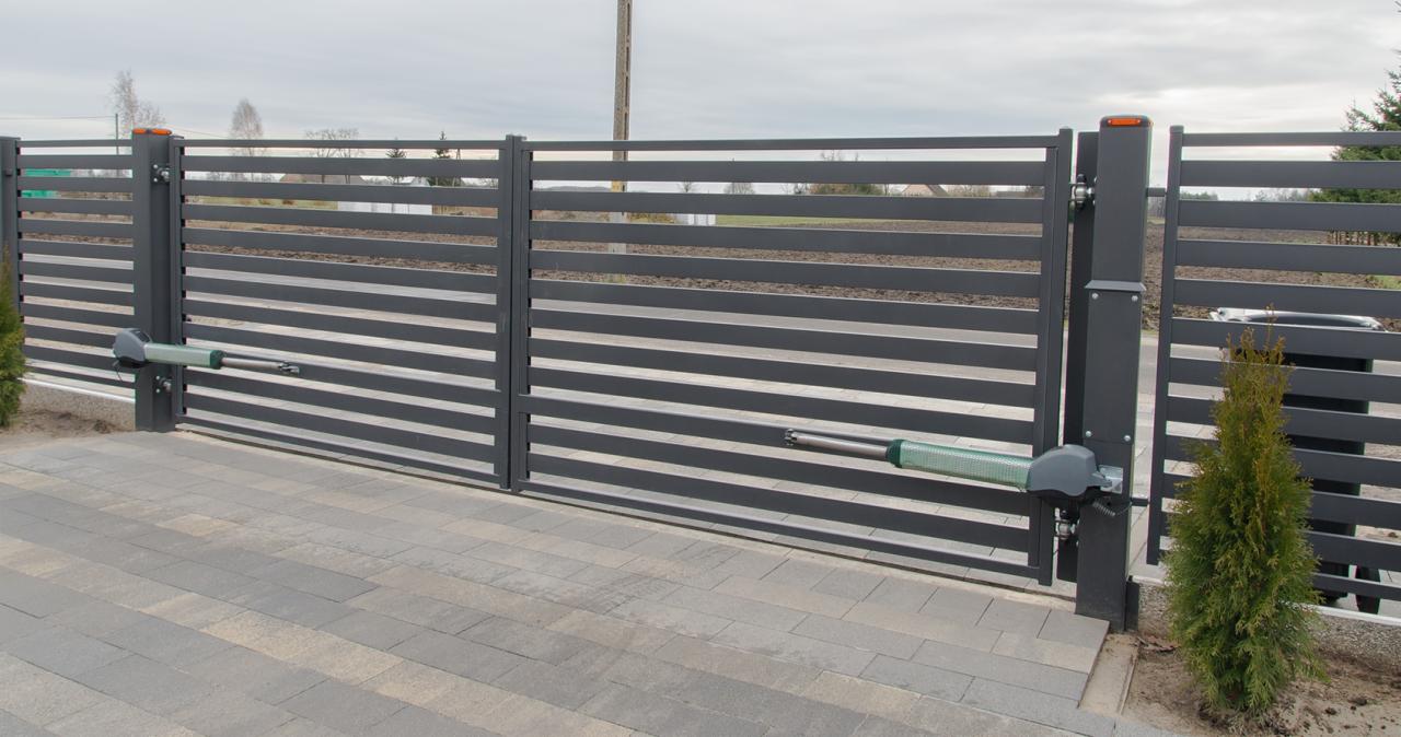 Automatyczna brama wjazdowa z poziomymi panelami w Gorzowie Wielkopolskim, widoczne siłowniki i kostka brukowa.