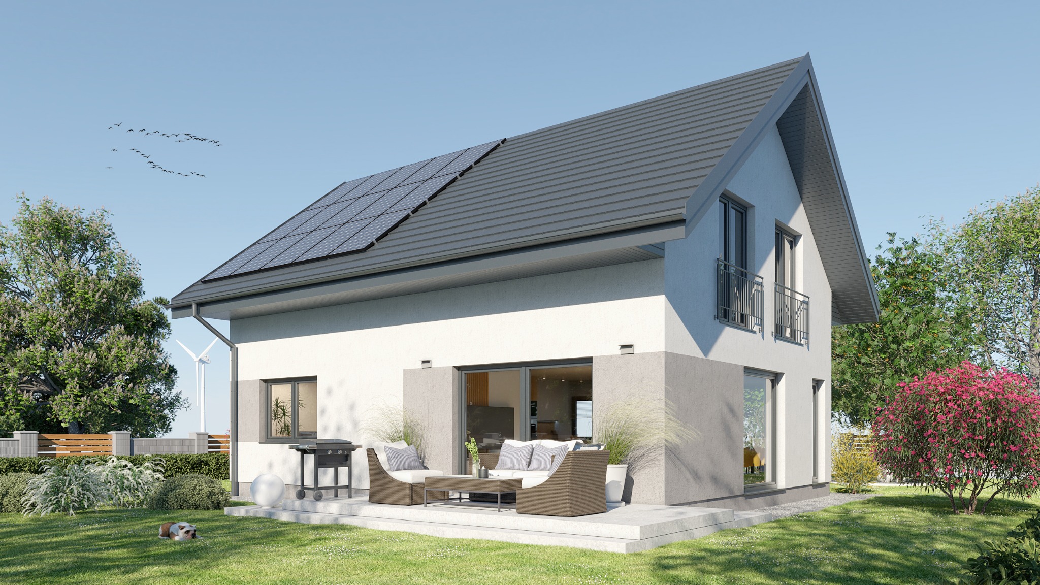 Nowoczesny dom z dwuspadowym dachem pokrytym panelami słonecznymi, z tarasem z meblami ogrodowymi, widok z zewnątrz w słoneczny dzień, z wiatrakiem w tle i psem leżącym na trawniku.