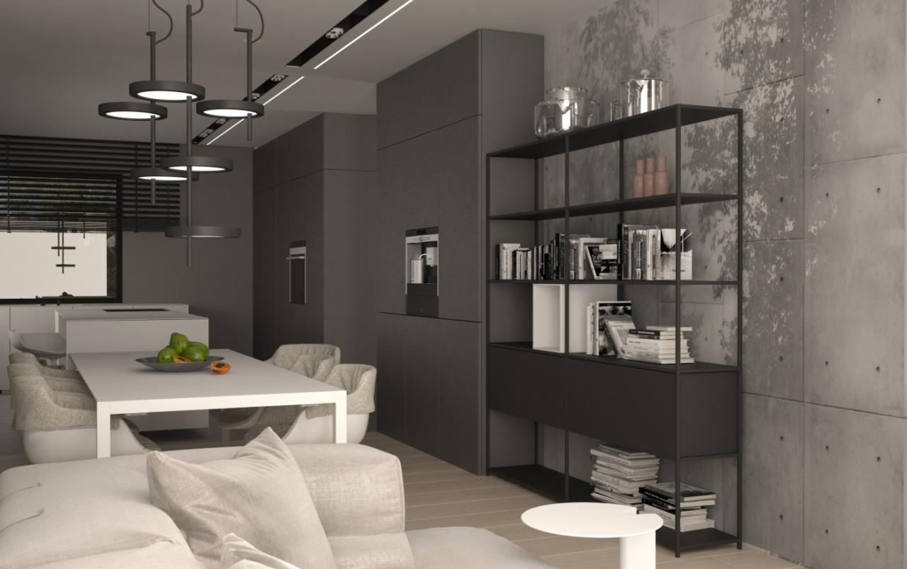 Nowoczesne wnętrze: szare szafki kuchenne z wbudowanym ekspresem do kawy, stół z owocami, metalowy regał z książkami na tle betonowej ściany z efektem dekoracyjnym.